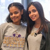 Two students wearing college gear