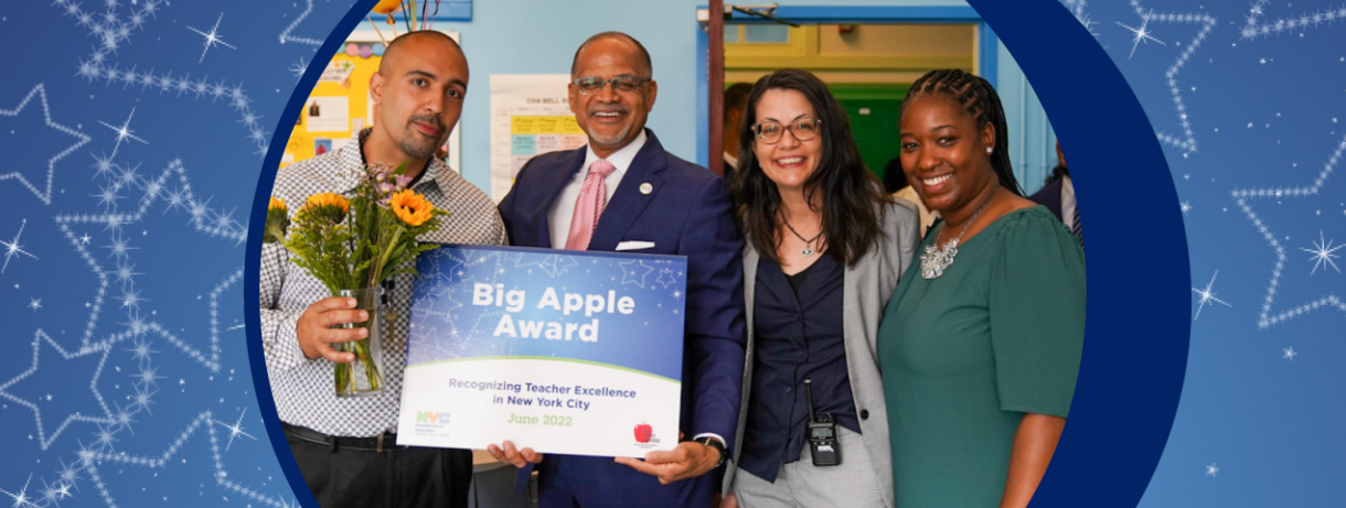 Chancellor Banks standing with teachers holding the 2022 Big Apple Award