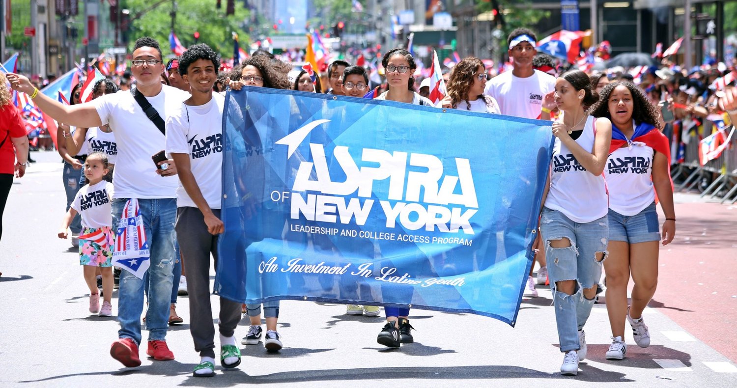 Teenagers carrying the ASPIRA of NY banner during the Puerto Rican Day Parade