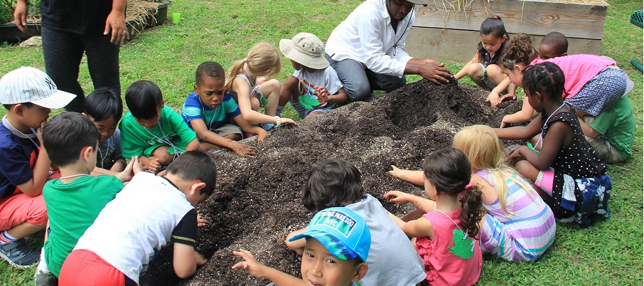 Young children getting into the dirt at the Environmental Study Center