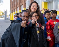 A teacher and student dressed as wizards with the Chancellor.