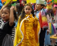 A student dressed as a princess parades with her classmates.