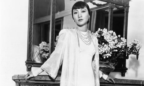  black and white photograph of Anna May Wong in a white gown.
