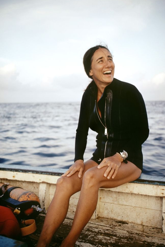 Color photograph of Eugenie Clark sitting on a boat with the ocean in the background.