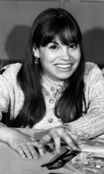 Black and white photograph of Judy Heumann in 1970 sitting at a table.