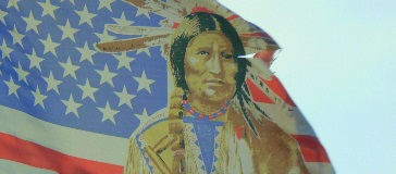 Image of an American flag with a Native American man in headdress drawn on top of it