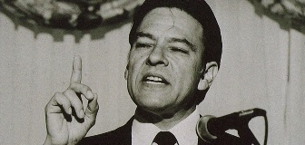 Willie Velasquez in mid-speech while standing at a podium.
