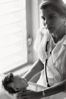 Dr. Helen Rodriguez-Trias holding a newborn baby in a hospital in Puerto Rico