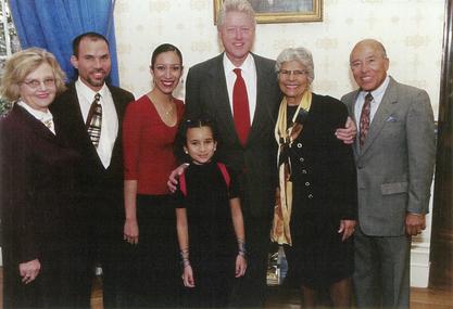 Dr. Helen Rodriguez-Trias (center, right) standing with President Bill Clinton (center) and her family after receiving the Presidential Citizens Medal in January 2001