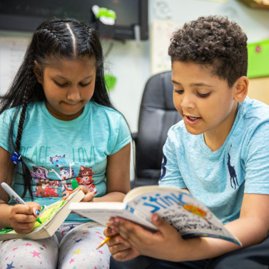 Image of two students reading.