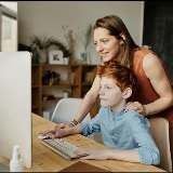 Mom and child looking at a monitor