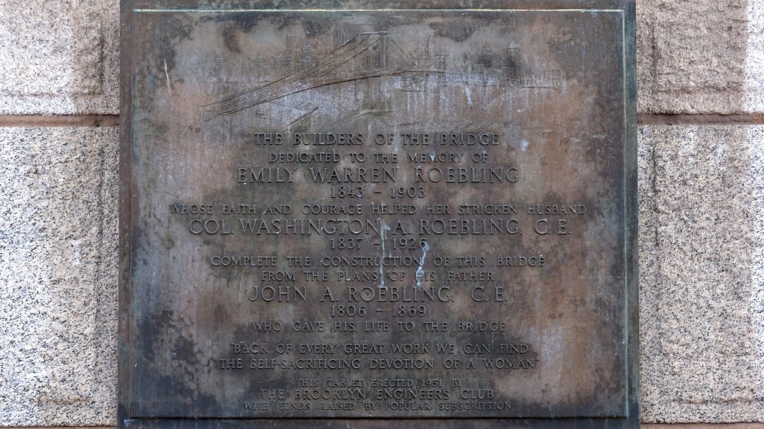 Metal plaque that reads "The Builders of the Bridge—Dedicated to the memory of Emily Warren Roebling."