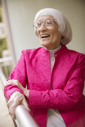 Older woman, Bernice Sandler, with short white hair in pink jacket, smiling