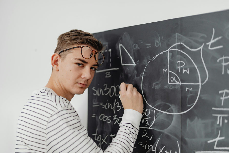 Male student solving for the sine and cosine of a triangle.
