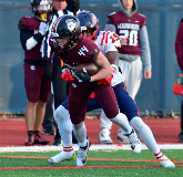 Nick Moukazis, #44, attempting to rush for positive yardage against Erasmus Hall defenders